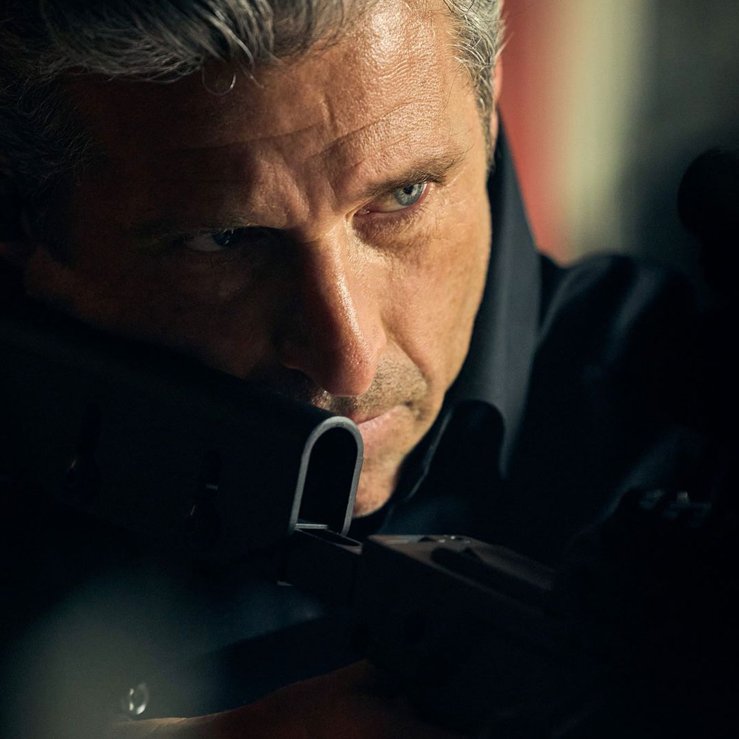 Image may contain Patrick Dempsey Firearm Weapon Gun Adult Person Shooting Face Head and Rifle