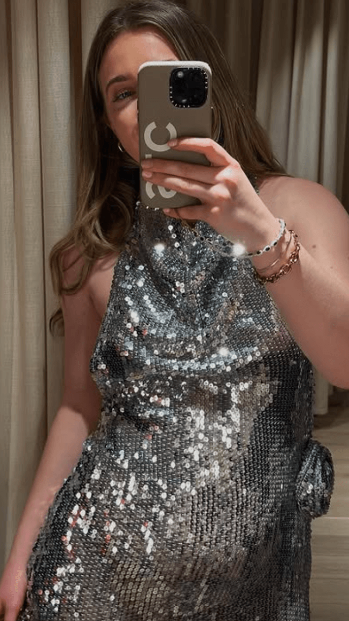 Image may contain Face Head Person Clothing Dress Photography Adult Electronics Mobile Phone and Phone